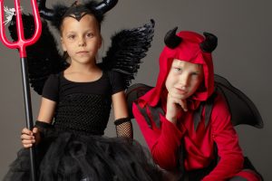a cute sibling pair in halloween costumes
