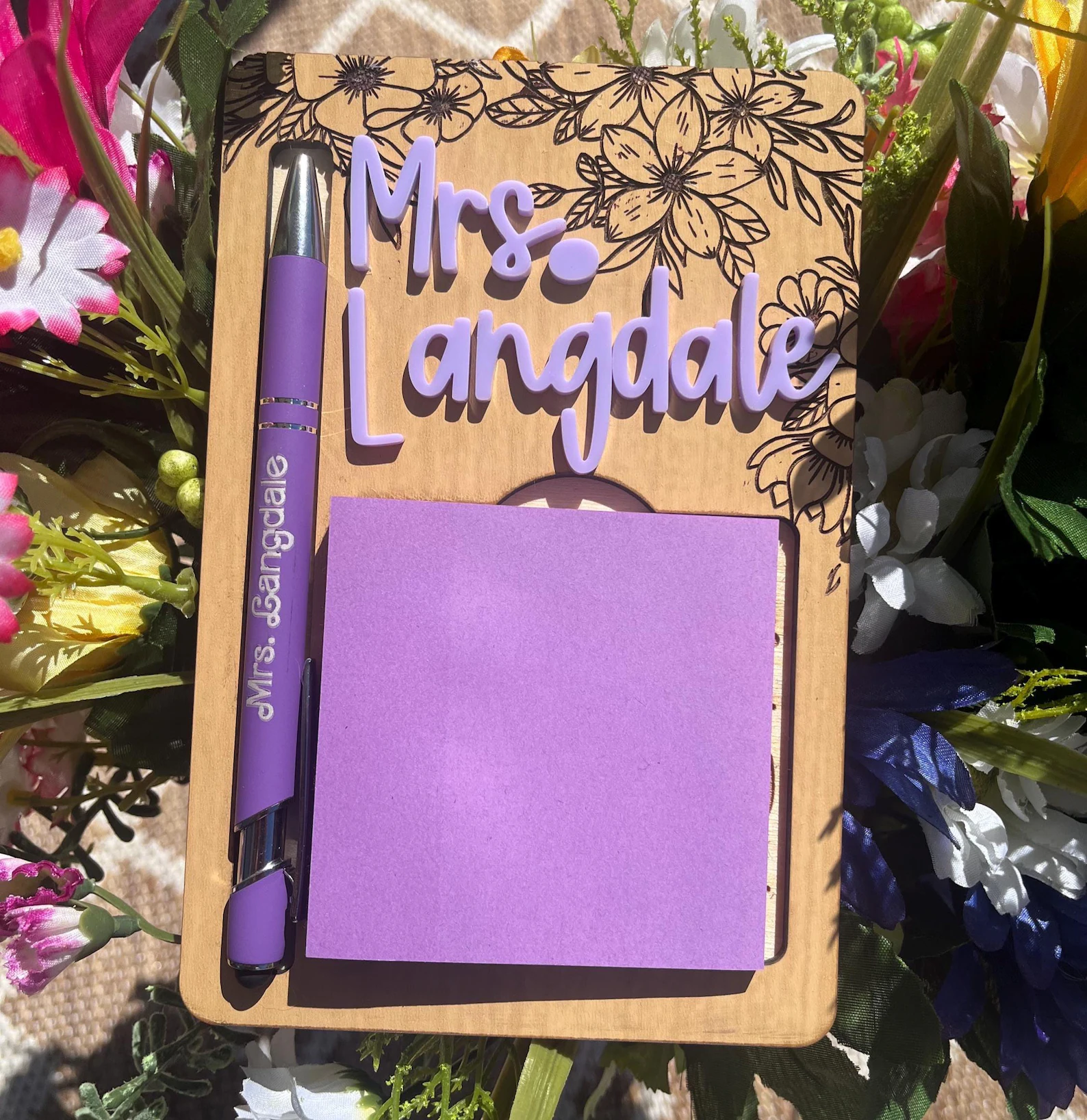 Personalized engraved wooden sticky note and pen holder with floral design and purple 3D name letters, a practical and pretty teacher appreciation gift ideas set for any classroom desk.