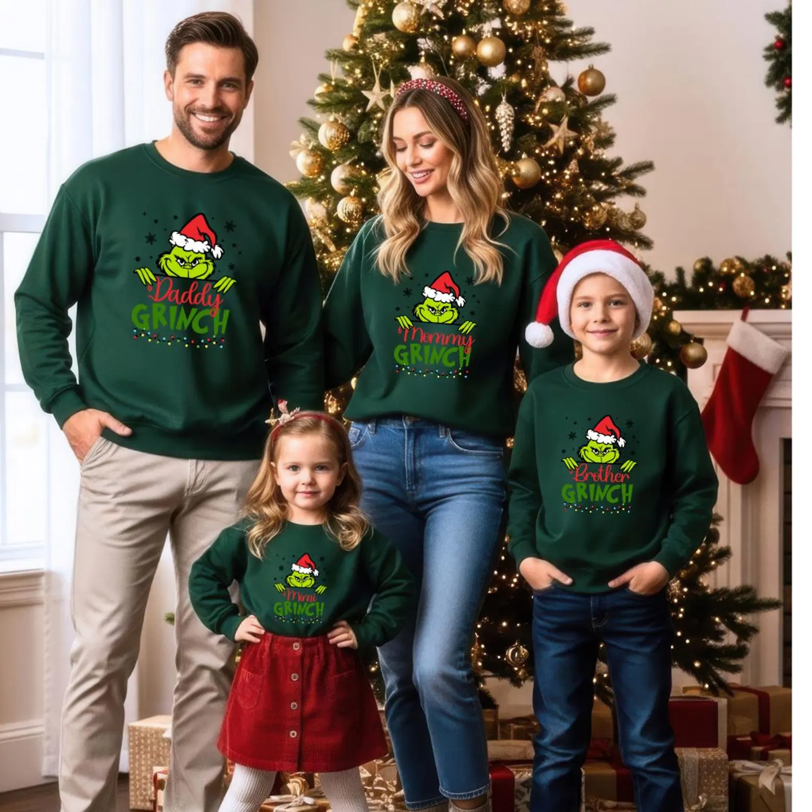 Happy family wearing matching forest green Daddy, Mommy, Brother and Mini Grinch personalized sweatshirts beside a decorated Christmas tree, cozy and festive Grinch party outfit ideas for families.