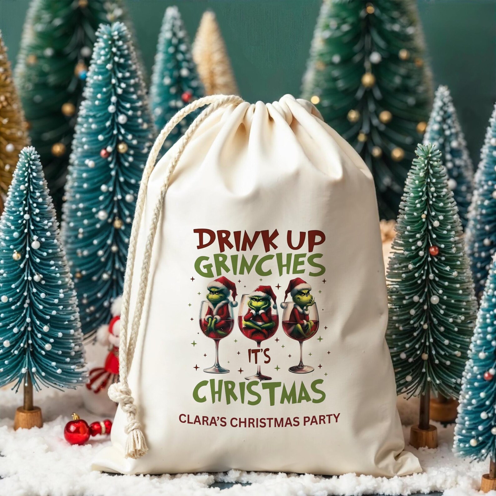 Personalized natural canvas drawstring favor bag printed with Drink Up Grinches It's Christmas and three Grinches in wine glasses, a reusable and memorable Grinch party keepsake bag for guests.